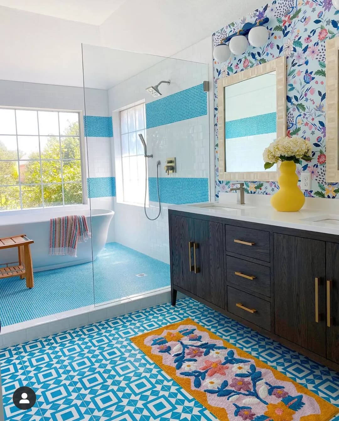 Bright, modern bathroom featuring colorful tile patterns, a freestanding tub, and a stylish vanity.